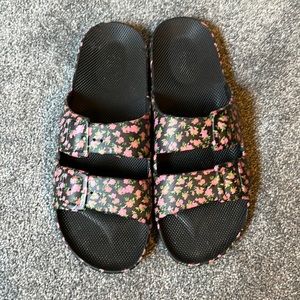 Freedom Moses plastic sandals with black floral print